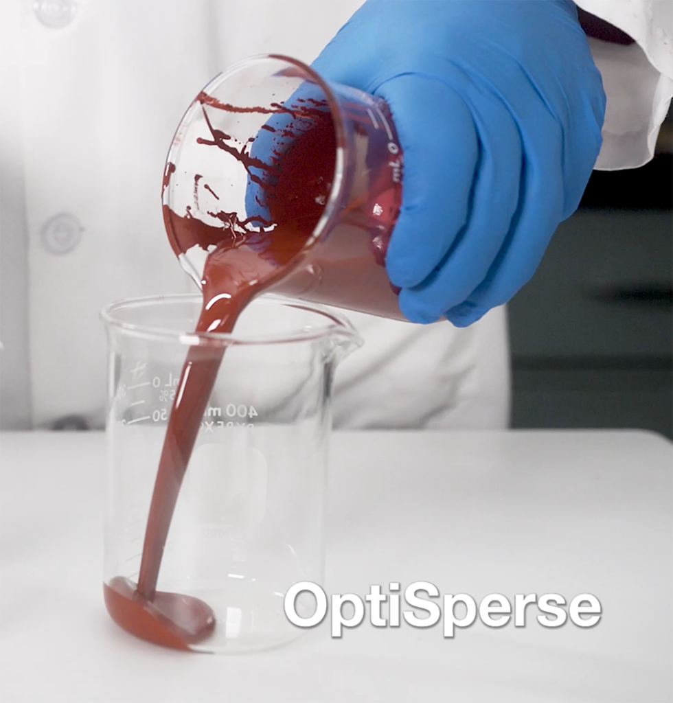 OptiSperce treated pigment pouring into a beaker